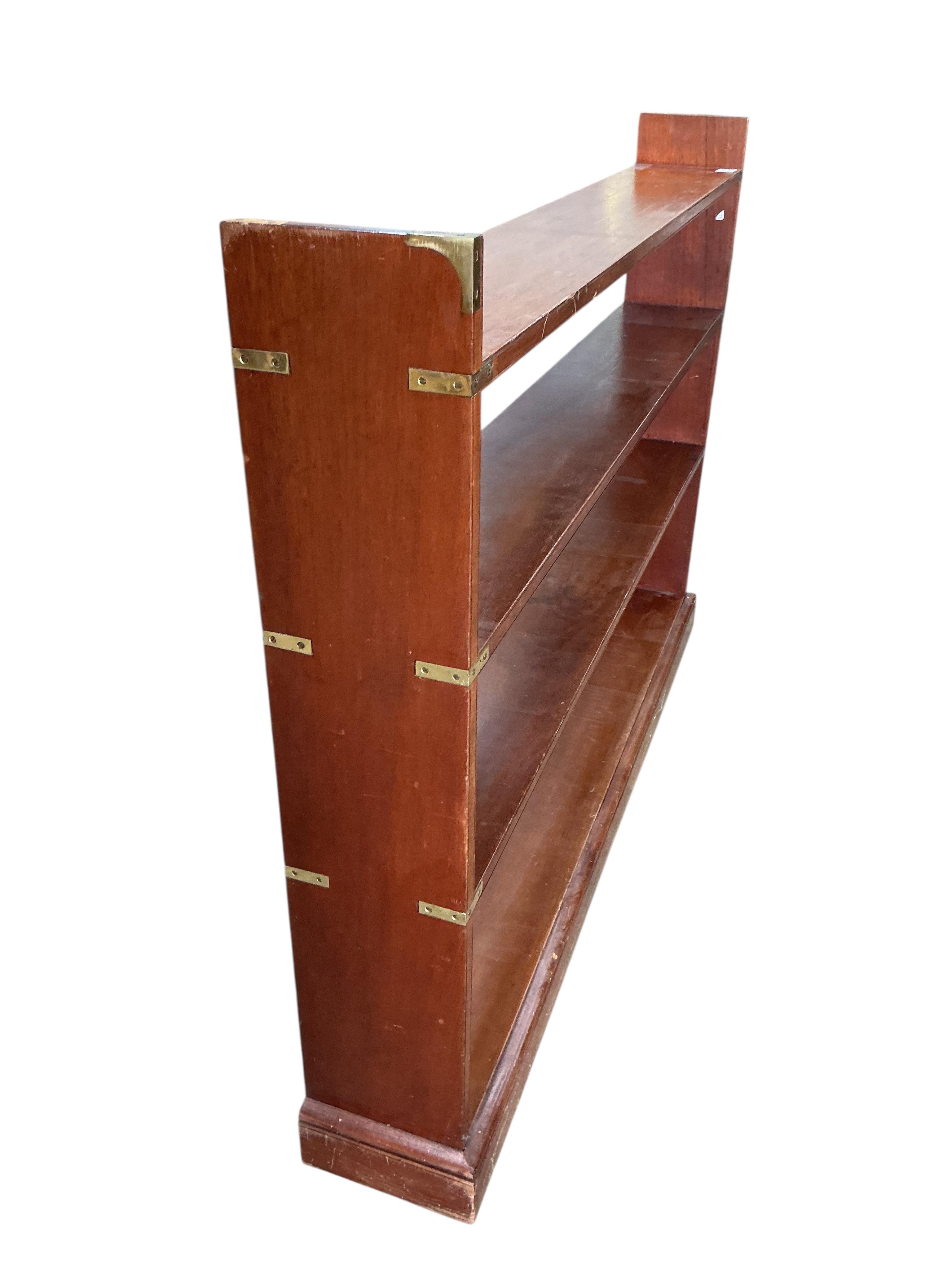 A military style brass mounted mahogany open bookcase, width 150cm, depth 23cm, height 108cm